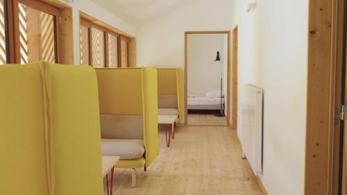 a row of chairs in a room with a bedroom at La Résidence Inco in Saint-Bertrand-de-Comminges