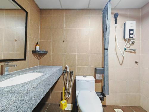 a bathroom with a toilet and a sink and a shower at Desaru Black Beach Sky Mirror Resort in Desaru