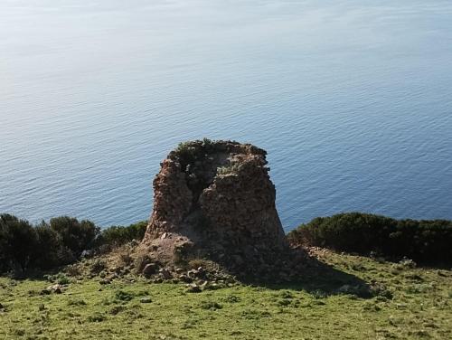 a rock formation on the side of a body of water at Da Rita in Villanova Monteleone