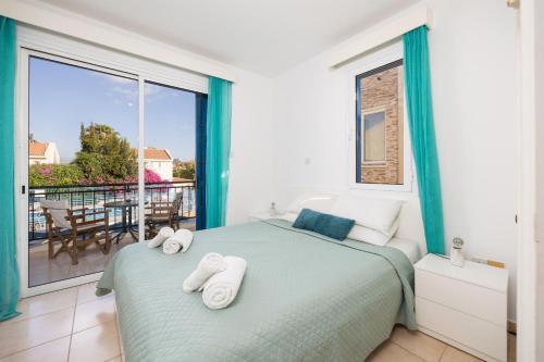 a bedroom with a bed and a large window at Latchi Harbour Maisonette in Lachi