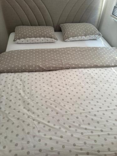 a bed with two pillows on top of it at Apartment Victoria in Foča