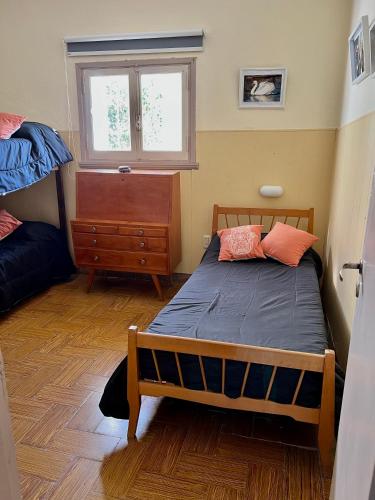 a bedroom with a bed and a dresser and a window at Espectacular Chalet para 5 personas in Miramar