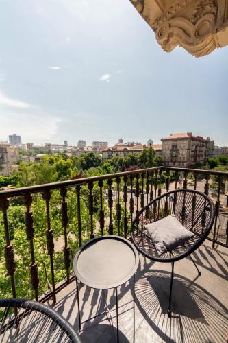 a balcony with two chairs and a table at DayFlat Apartments Maidan Area in Kyiv