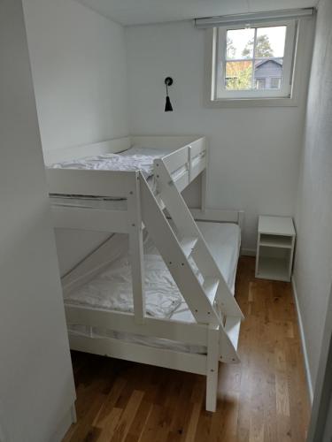 a white bunk bed in a room with a window at Centrum apartment Lindvallen in Sälen