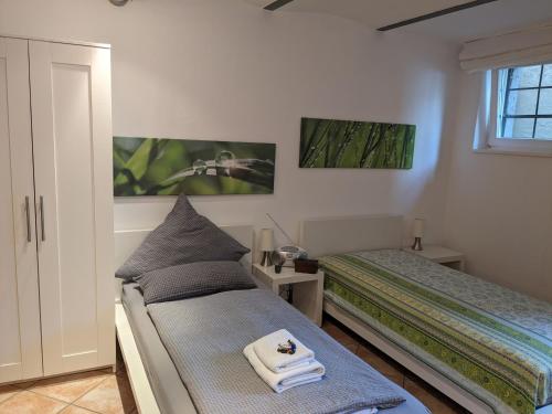 a bedroom with two beds and towels on a bench at Apartment Familie Scheibel in Bad Vilbel