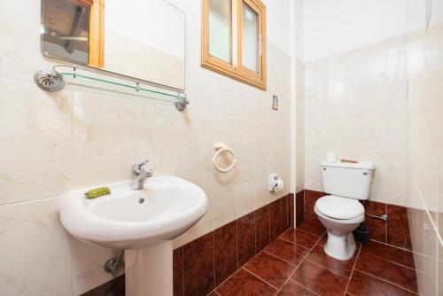 a bathroom with a sink and a toilet at Villa Angela Paradise in Argaka