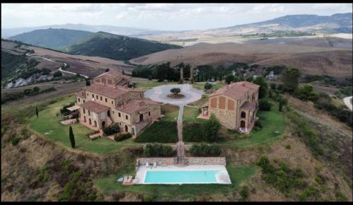 an aerial view of a mansion with a swimming pool at Catignano A6 - Modern unit, scenic Volterra hills in Mazzolla