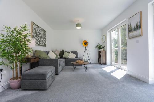 a living room with a couch and a table at 8 Iris Cottage, Coastal Hideaway - Suffolk in Wenhaston