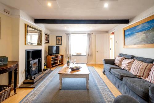 a living room with a couch and a coffee table at Sea View, Thorpeness in Thorpeness