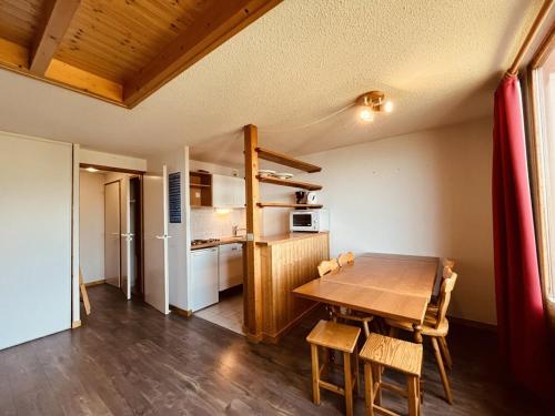 une cuisine et une salle à manger avec une table et des chaises en bois dans l'établissement Duplex 8 pers, skis aux pieds à Vallandry, proche centre, balcon - FR-1-757-128, à Landry