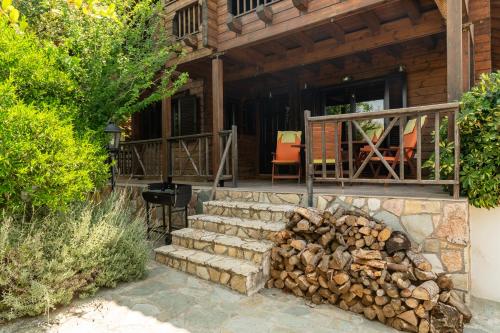 a pile of fire wood in front of a house at Bright and cozy cottage near the sea in Káto Alepokhórion