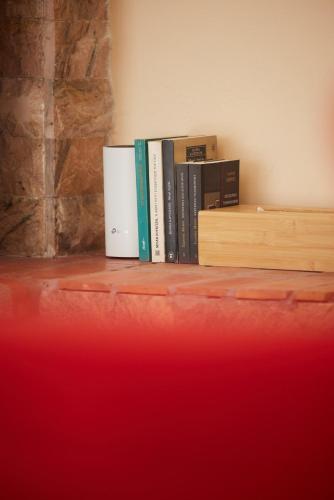 a row of books sitting on a shelf at Cozy Flat near Kato Samiko Beach in Káto Samikón