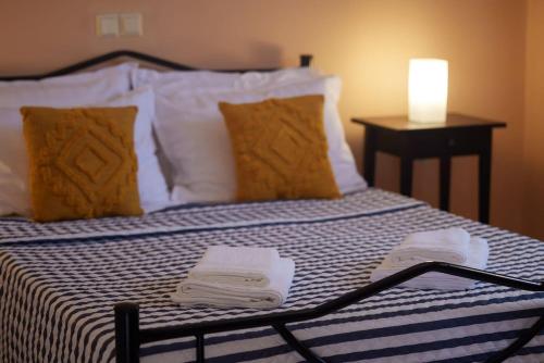 a bed with two towels on top of it at Cozy Flat near Kato Samiko Beach in Káto Samikón