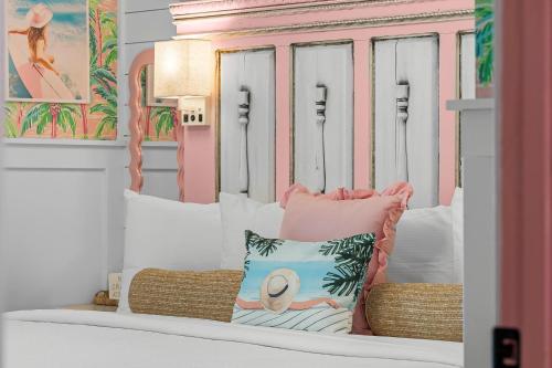 a bench with pillows on it in a room at Pink Prerogative Beach Bungalow with Private Pool in Panama City Beach