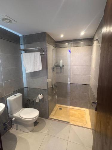 a bathroom with a shower and a toilet at avenue compound in Hurghada
