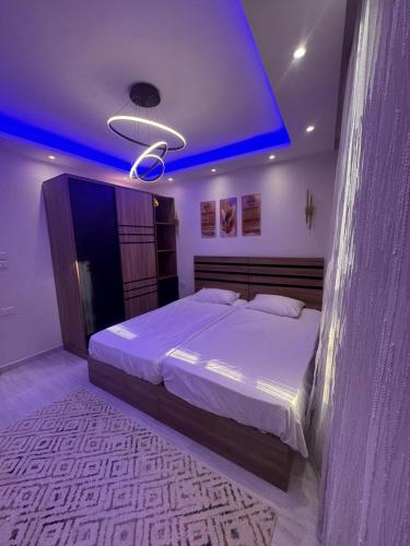 a bedroom with a large bed with a blue ceiling at avenue compound in Hurghada