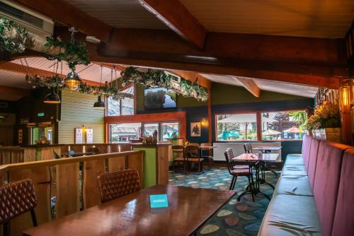 a restaurant with tables and chairs and a bar at Sandy Balls Holiday Village in Fordingbridge