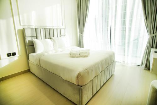 a bedroom with a large bed in front of a window at Brand New Studio In Tulip JVC in Dubai