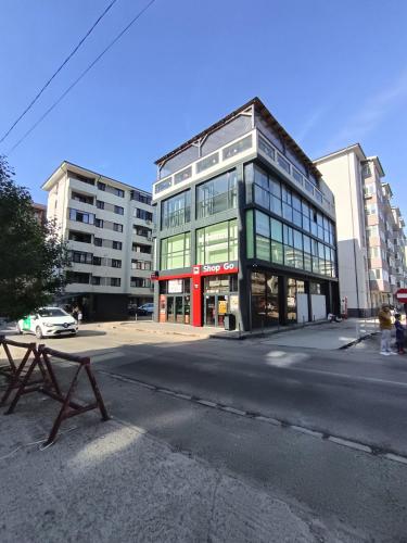 a building on the corner of a city street at Elegant Studio Militari Private Parking Self check in Netflix New building in Bucharest