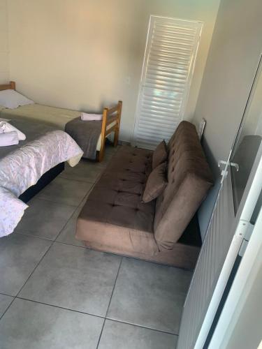 a couch sitting in the middle of a room at Space Mistieri in Espirito Santo Do Pinhal