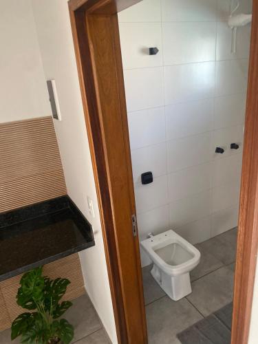a bathroom with a toilet and a sink at Space Mistieri in Espirito Santo Do Pinhal