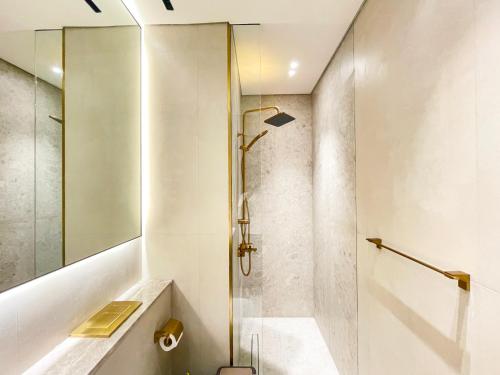 a bathroom with a shower and a toilet and a sink at Brand New Studio In Tulip JVC in Dubai