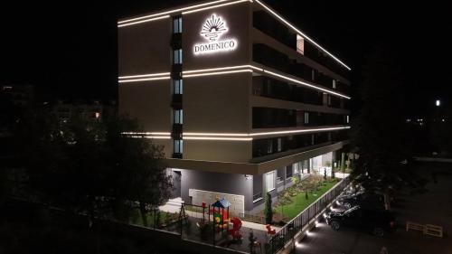 a building with a sign on the side of it at Domenico Luxury Apartments in Sunny Beach