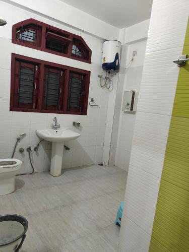 a bathroom with a sink and a toilet at Hotel serenity villa in Guwahati