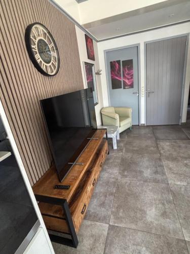 a living room with a flat screen tv on a wall at Appartementen De Helling 44 in Heeg