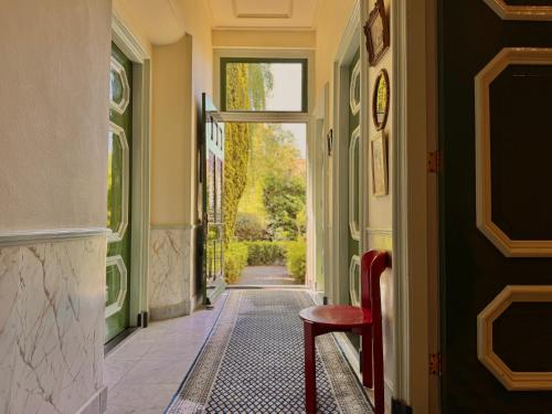 a hallway with a red stool in a hallway at Villa Abbekerk - Bed & Breakfast in Abbekerk