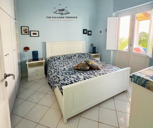 a bedroom with a white bed in a room at The Vulcano Terrace in Vulcano