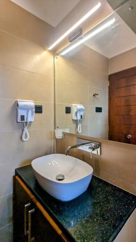 a bathroom with a white sink and a mirror at Royal Lion Hotel - Kandy Road, Galagadara in Galagedara