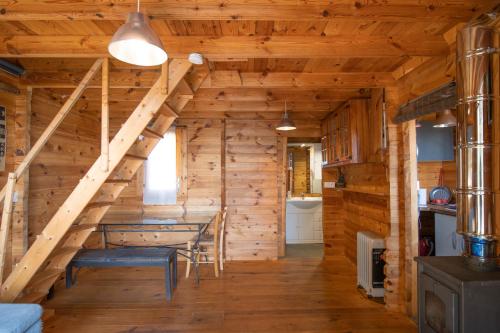 a dining room and kitchen in a log cabin at Villa a Croce in Alata