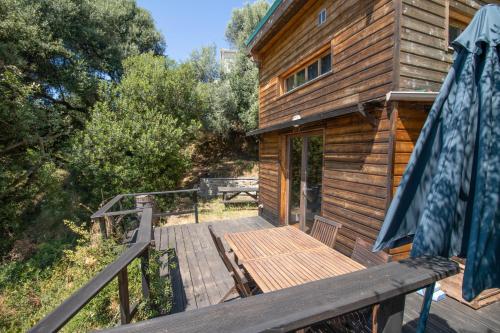 a wooden deck on the side of a cabin at Villa a Croce in Alata