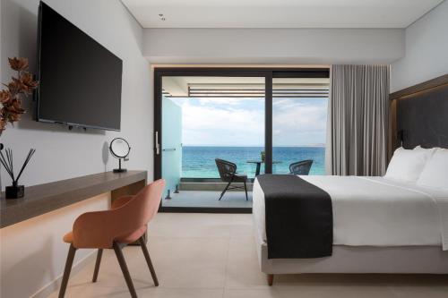 a bedroom with a bed and a view of the ocean at Avant Blue Boutique Hotel in Korinthos