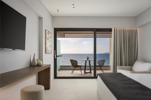 a bedroom with a bed and a view of the ocean at Avant Blue Boutique Hotel in Korinthos