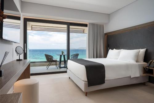 a bedroom with a bed and a view of the ocean at Avant Blue Boutique Hotel in Korinthos
