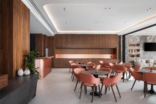 a restaurant with wooden walls and tables and chairs at Avant Blue Boutique Hotel in Korinthos