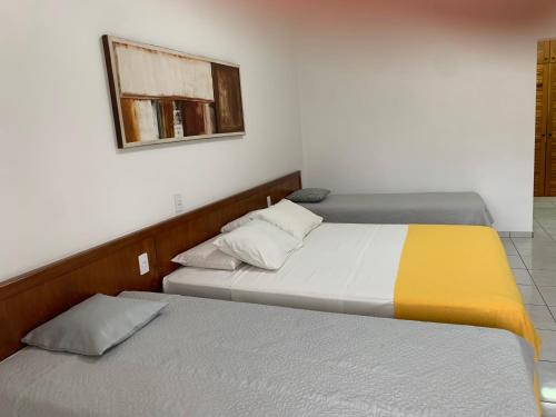 two beds sitting next to each other in a room at Riviera- Hotel Suite Família in Riviera de São Lourenço