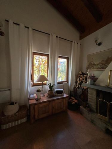 a living room with a table and two windows at Chalet St John in Slatino