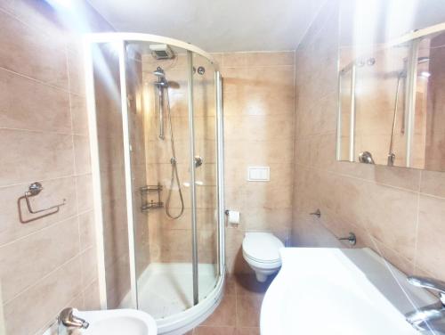 a bathroom with a shower and a toilet and a sink at Mamma Casa City Center Lampone in Rimini