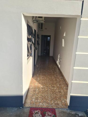 an empty hallway with a tile floor in a building at Likhanyile Guest Lodge in Nhlangano