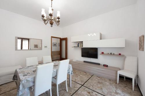 a dining room with a table and a television at La Casa Della Gioia - Serravalle in Serravalle Scrivia