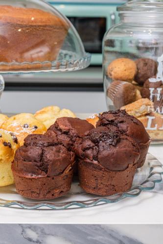 a plate of chocolate muffins and pastries on a counter at Dolce Marea Bed&Spa in Gaeta