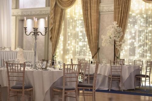 a dining room with a table and chairs and lights at The Newgrange Hotel in Navan