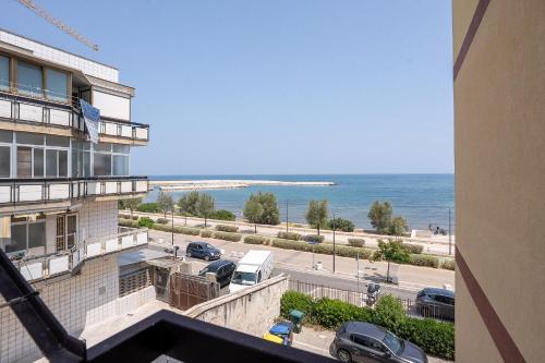 a view of the ocean from a balcony of a building at Dimora Waterfront in Bari