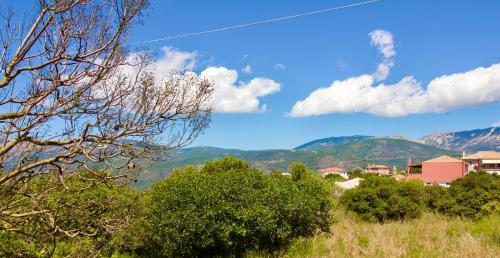 a town with trees and mountains in the background at Archontariki Luxury suites collection in Lakithra village in Lakithra