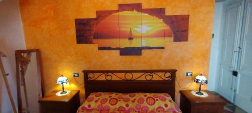 a bedroom with a bed and two night stands with lamps at Dimora Maltese in Morciano di Leuca