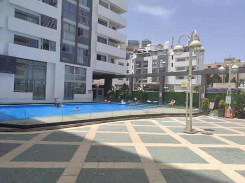 a swimming pool in the middle of a building at Seaview Tanger Apartment in Tangier