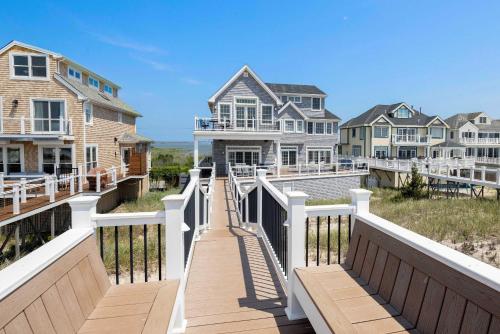 a boardwalk to the beach with houses and condos at Dunecrest by RoveTravel - Family Oceanfront with Heated Pool in Westhampton Beach